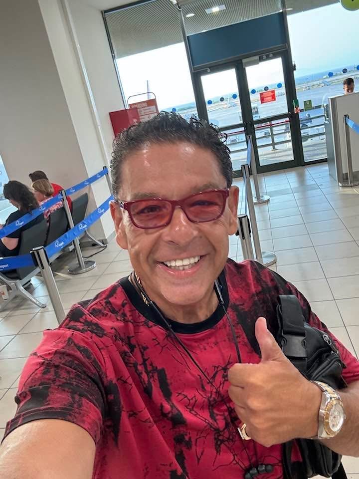 Greg Kritikos smiling at an airport