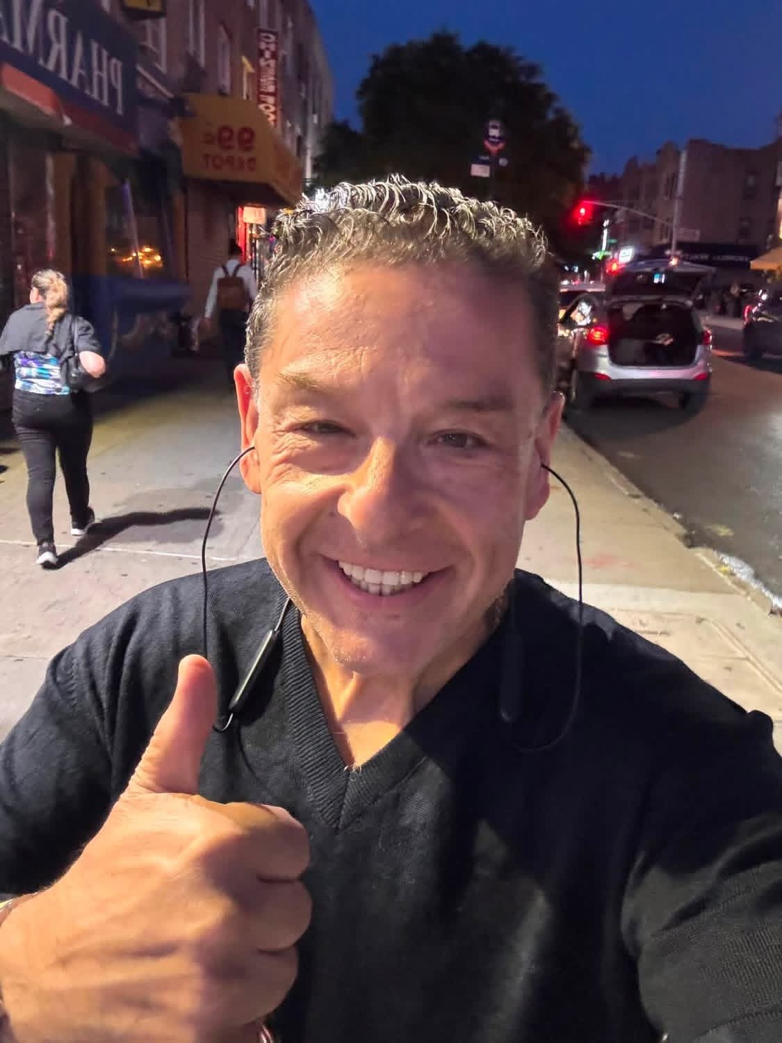 Greg Kritikos smiling on a city street at night